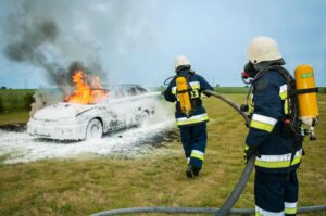 Firefighters extinguishing a burning car