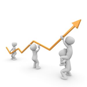 Figures holding and upward trending graph line